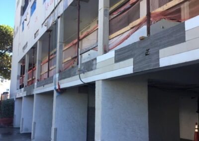 Under-construction building with scaffolding and safety netting.